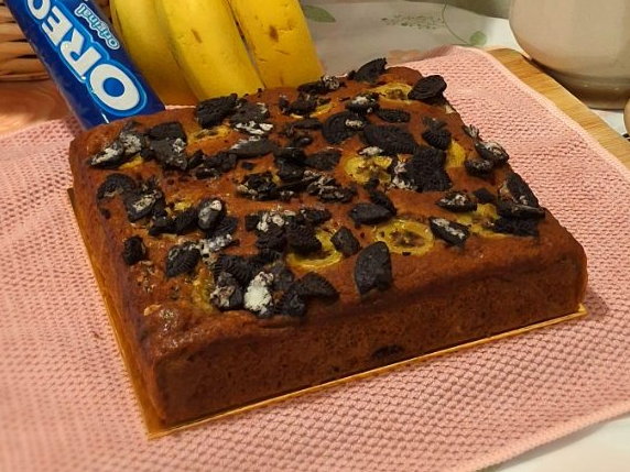 Oreo banana cake topped with crushed Oreo cookies