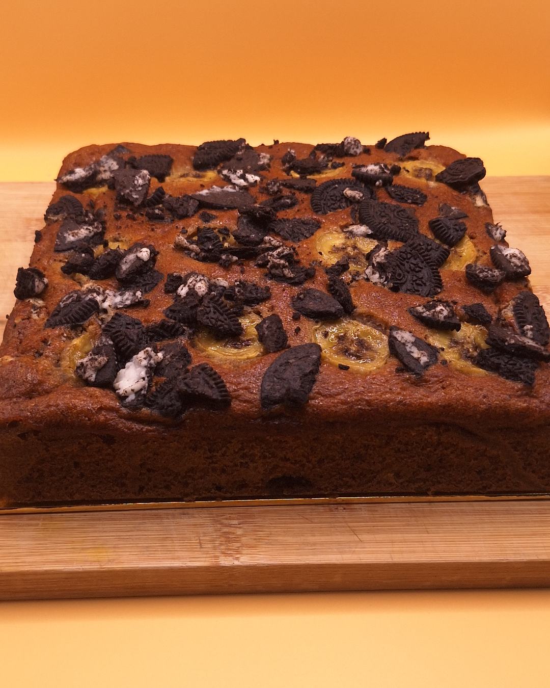 Freshly baked Oreo banana cake topped with crushed Oreo and banana slices